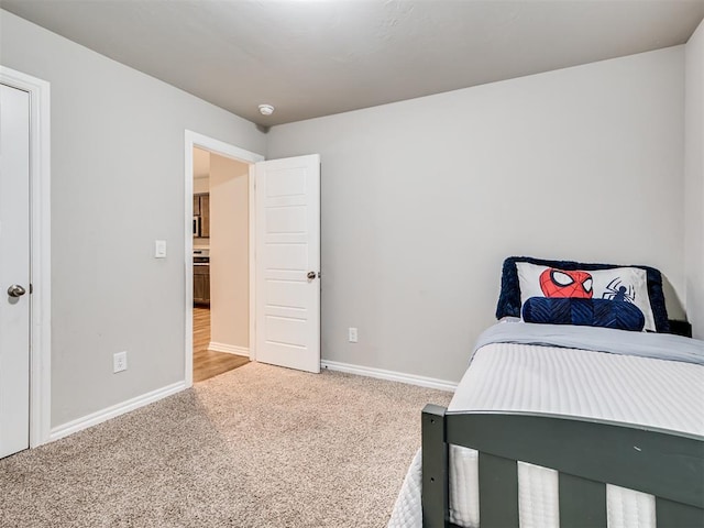 bedroom featuring baseboards and carpet flooring