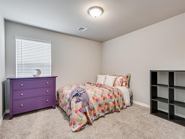 bedroom with baseboards, visible vents, and light colored carpet