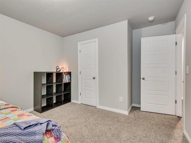 carpeted bedroom with baseboards