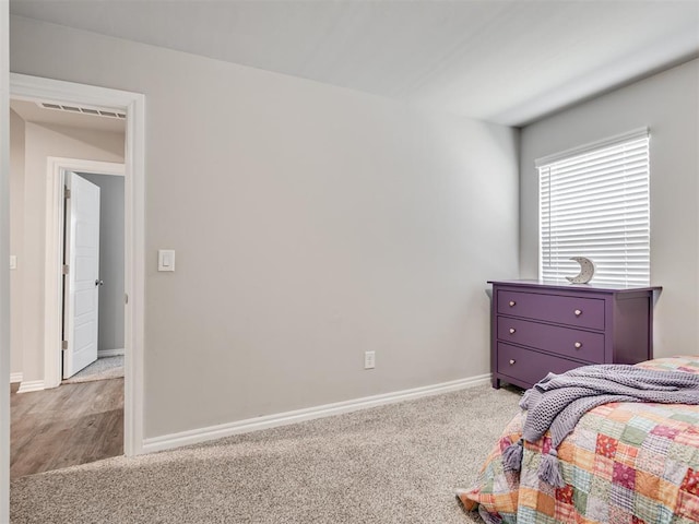 carpeted bedroom with baseboards