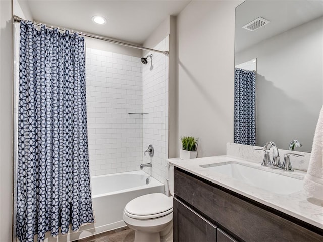 full bath with toilet, wood finished floors, vanity, visible vents, and shower / tub combo with curtain