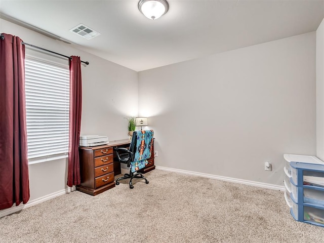 office with visible vents, baseboards, and light colored carpet