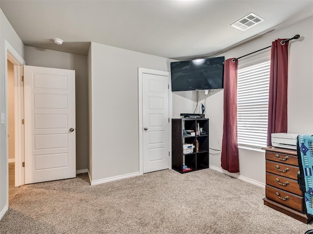 carpeted bedroom featuring baseboards, multiple windows, and visible vents