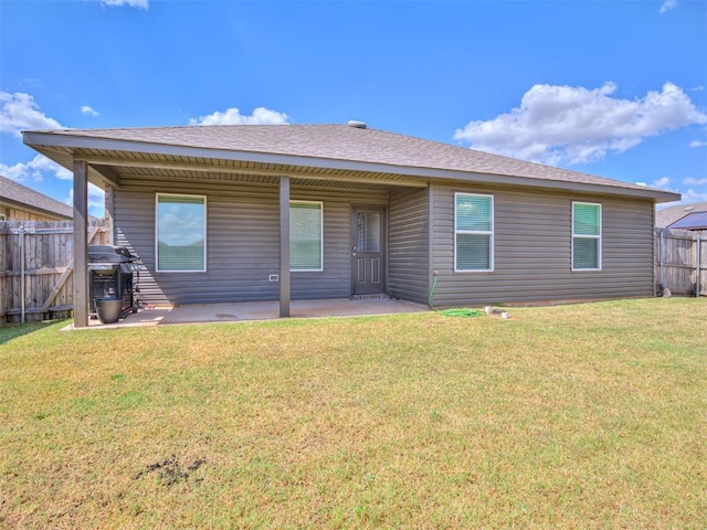 back of house with a yard, fence, and a patio