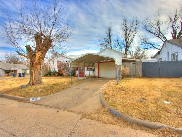 view of front of property featuring a detached garage and fence