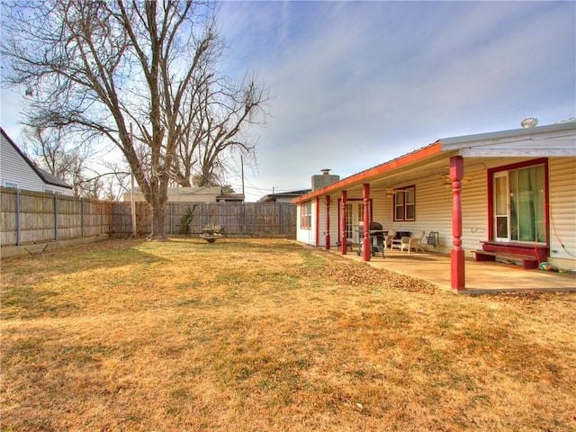 view of yard with a fenced backyard and a patio