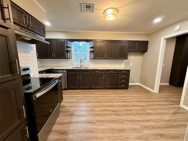 kitchen featuring dark brown cabinets, visible vents, stainless steel appliances, and a sink