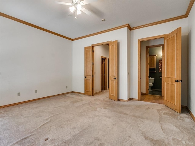 unfurnished bedroom with light carpet, baseboards, connected bathroom, and crown molding