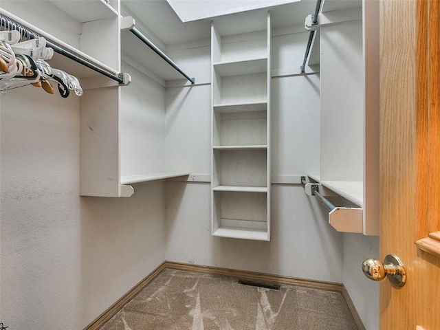 walk in closet featuring carpet floors and visible vents