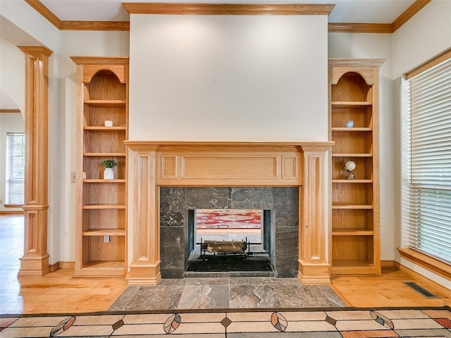 unfurnished living room with arched walkways, visible vents, crown molding, and a tiled fireplace