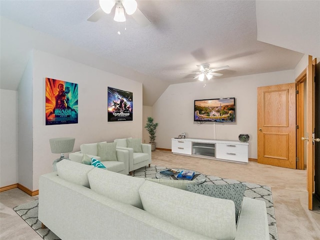 living room featuring ceiling fan, a textured ceiling, vaulted ceiling, and light colored carpet