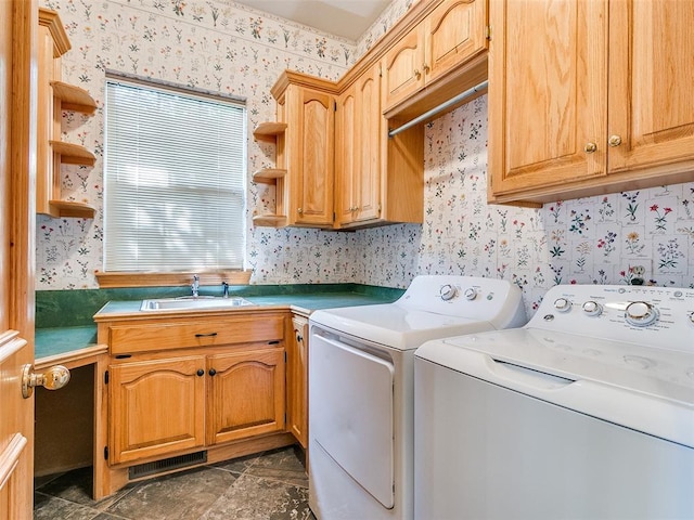 washroom with cabinet space, visible vents, a sink, separate washer and dryer, and wallpapered walls