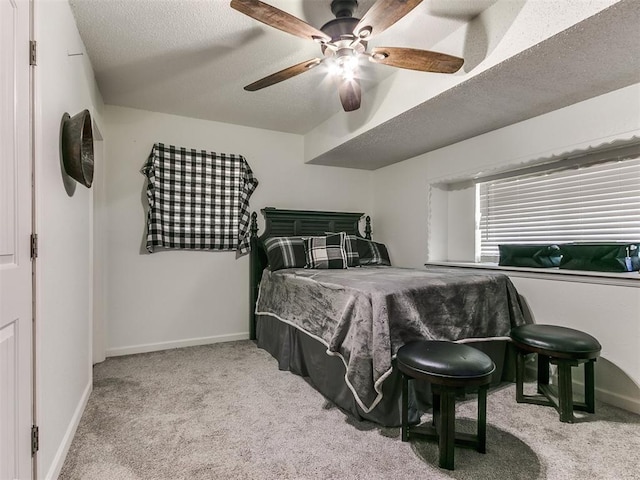 bedroom featuring carpet floors, a textured ceiling, baseboards, and a ceiling fan