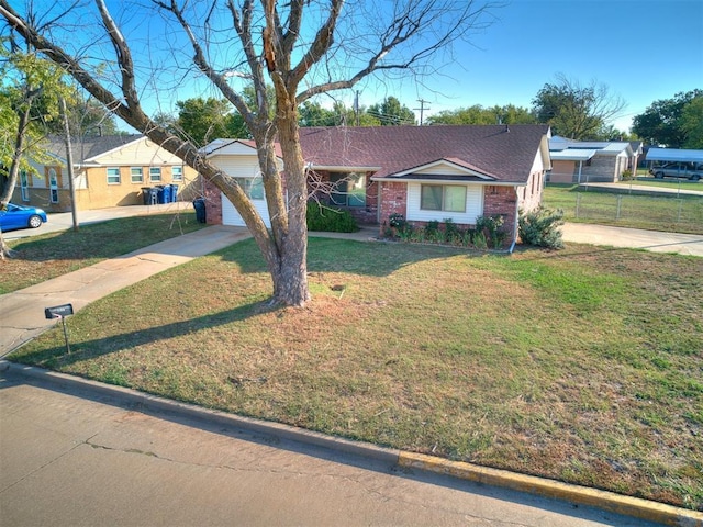 ranch-style house featuring brick siding, concrete driveway, an attached garage, fence, and a front lawn