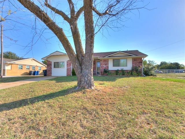 ranch-style house with brick siding and a front lawn