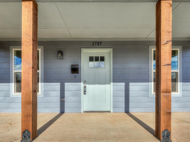 doorway to property with covered porch