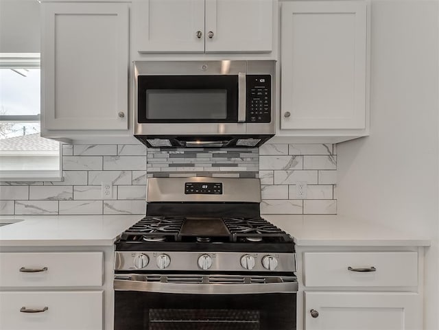 kitchen featuring white cabinetry, appliances with stainless steel finishes, and light countertops