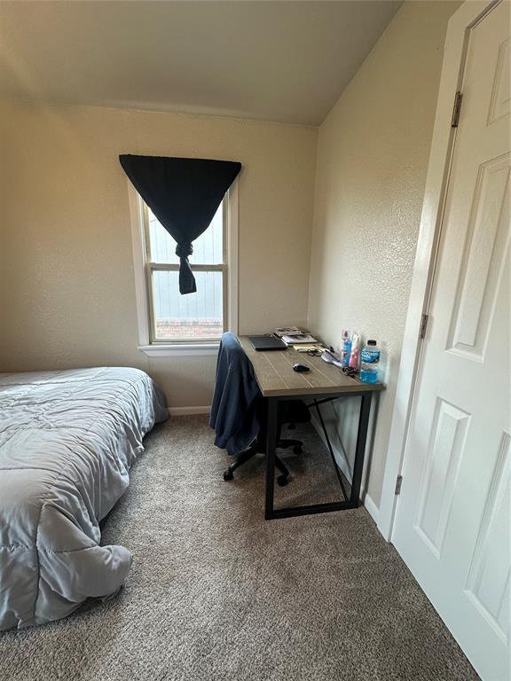 carpeted bedroom featuring baseboards