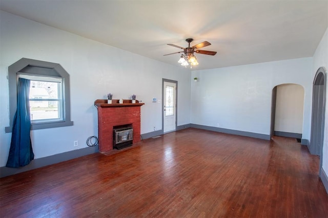 709 S Broadway, Geary, OK 73040 - living area featuring a brick fireplace, wood finished floors, a wealth of natural light, and ceiling fan
