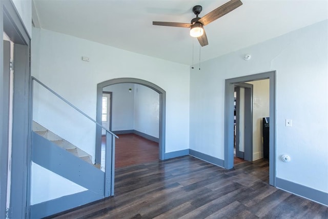 709 S Broadway, Geary, OK 73040 - spare room featuring arched walkways, stairway, ceiling fan, and wood finished floors