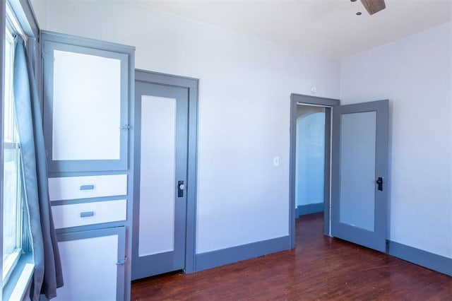 709 S Broadway, Geary, OK 73040 - unfurnished room with baseboards, a ceiling fan, and dark wood-style flooring
