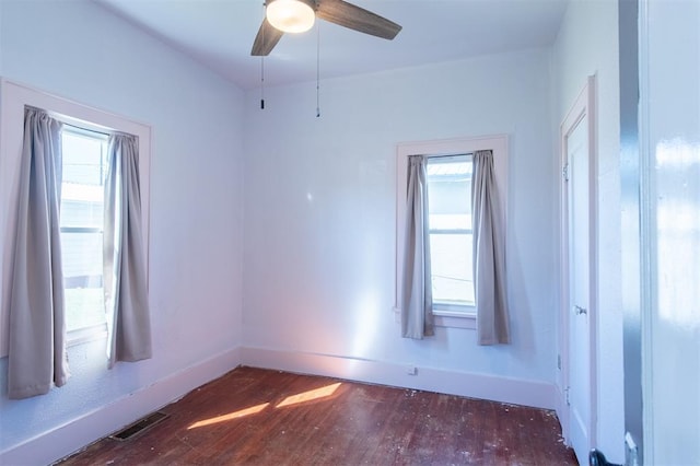 709 S Broadway, Geary, OK 73040 - spare room featuring a ceiling fan, wood finished floors, visible vents, and baseboards