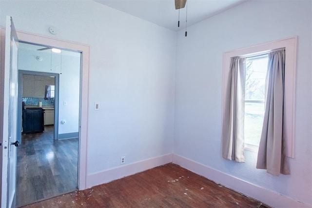 709 S Broadway, Geary, OK 73040 - unfurnished room with a ceiling fan, wood finished floors, and baseboards