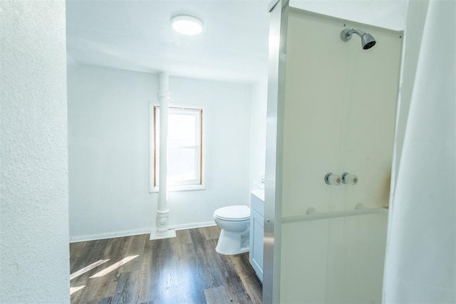 709 S Broadway, Geary, OK 73040 - full bathroom with vanity, wood finished floors, baseboards, a shower, and toilet