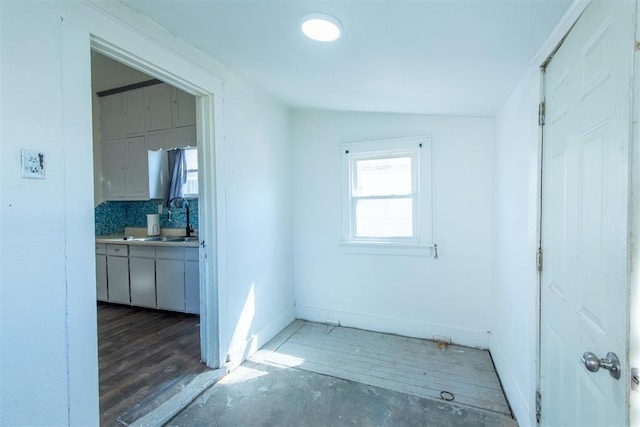709 S Broadway, Geary, OK 73040 - hall featuring baseboards and a sink