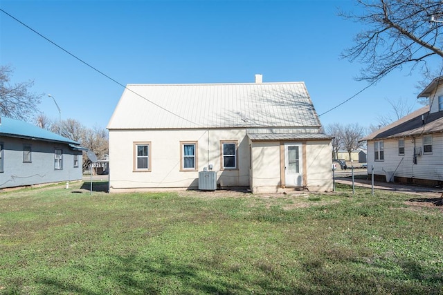 709 S Broadway, Geary, OK 73040 - back of property with central air condition unit, metal roof, and a yard