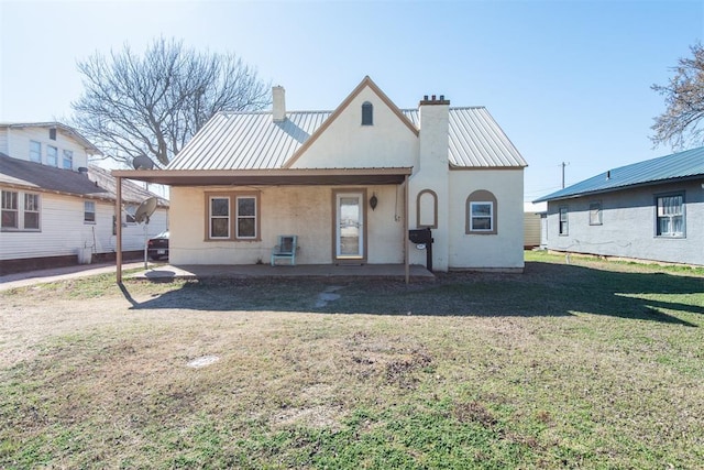 709 S Broadway, Geary, OK 73040 - back of house featuring a yard, a chimney, and metal roof