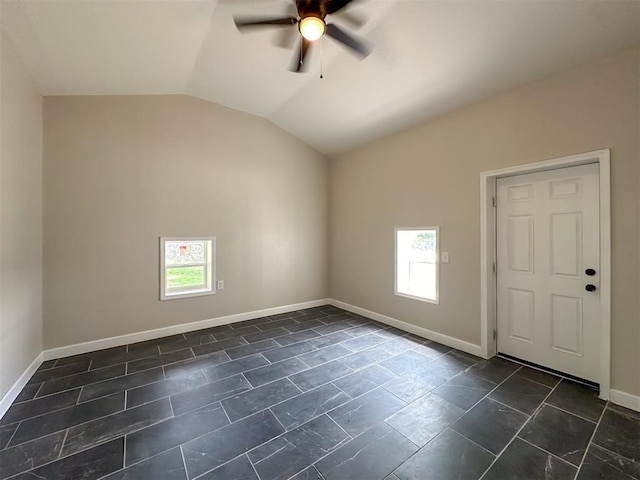 spare room featuring a ceiling fan, vaulted ceiling, and baseboards