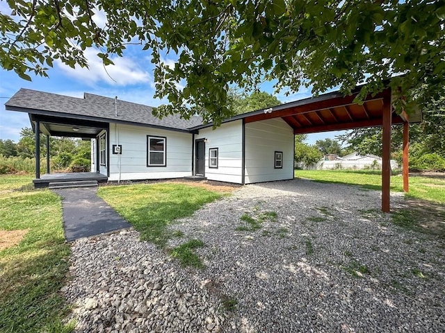 view of front of property featuring a carport, a front yard, and driveway