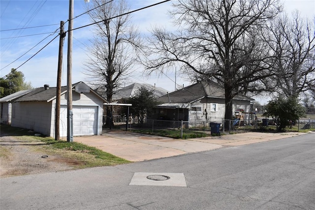 201 N Williams Ave, El Reno, OK 73036 - view of front facade featuring fence, an outdoor structure, driveway, and a detached garage