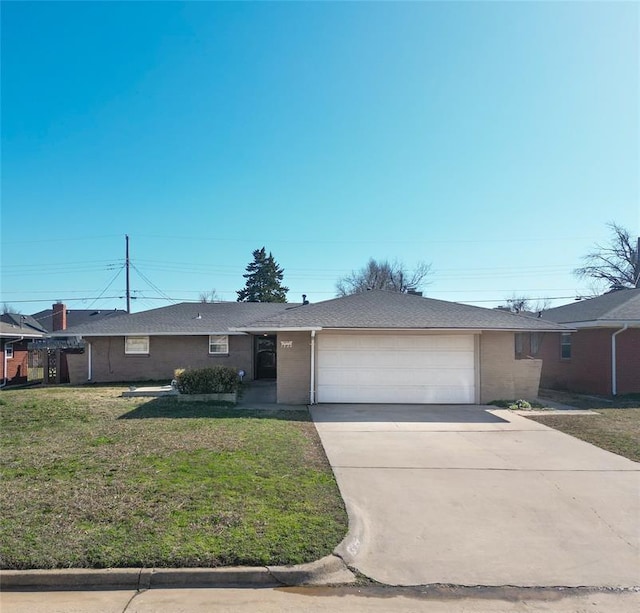 ranch-style house with a garage, driveway, and a front lawn