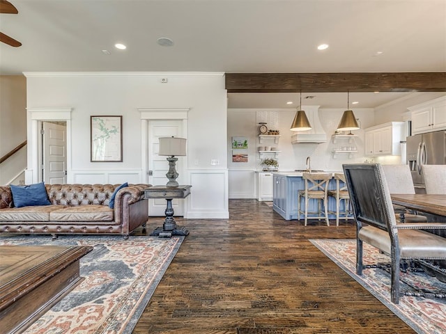 39 Boulevard, Carlton Landing, OK 74432 - living room with dark wood-style flooring, beam ceiling, recessed lighting, ornamental molding, and wainscoting