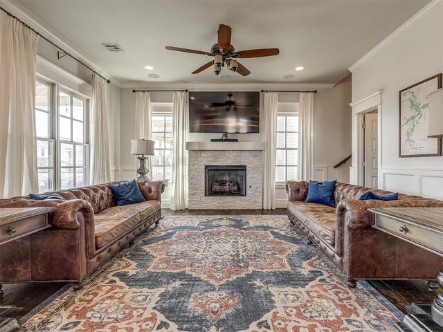 39 Boulevard, Carlton Landing, OK 74432 - living area featuring a healthy amount of sunlight, visible vents, a decorative wall, and crown molding