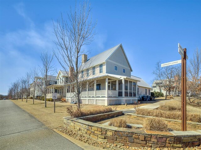 39 Boulevard, Carlton Landing, OK 74432 - farmhouse inspired home with a sunroom, metal roof, and a chimney