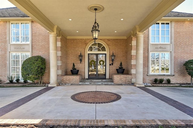 doorway to property with brick siding and french doors