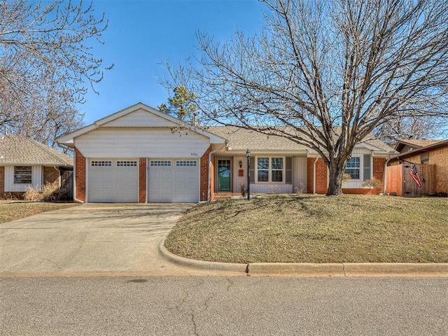 ranch-style house with a front yard, concrete driveway, brick siding, and an attached garage