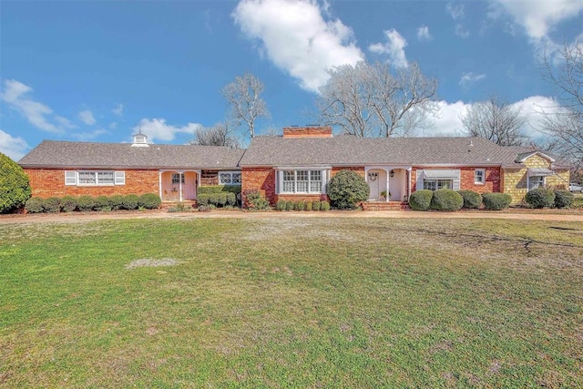 ranch-style home featuring a front yard and brick siding