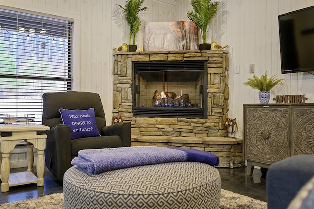 sitting room featuring a stone fireplace