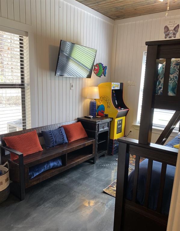 interior space with wood ceiling and concrete flooring