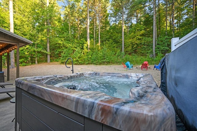 view of swimming pool featuring a hot tub