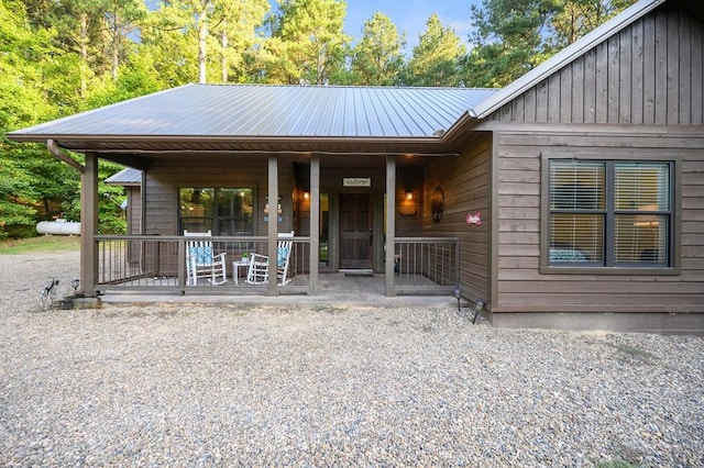 view of front facade featuring covered porch and metal roof