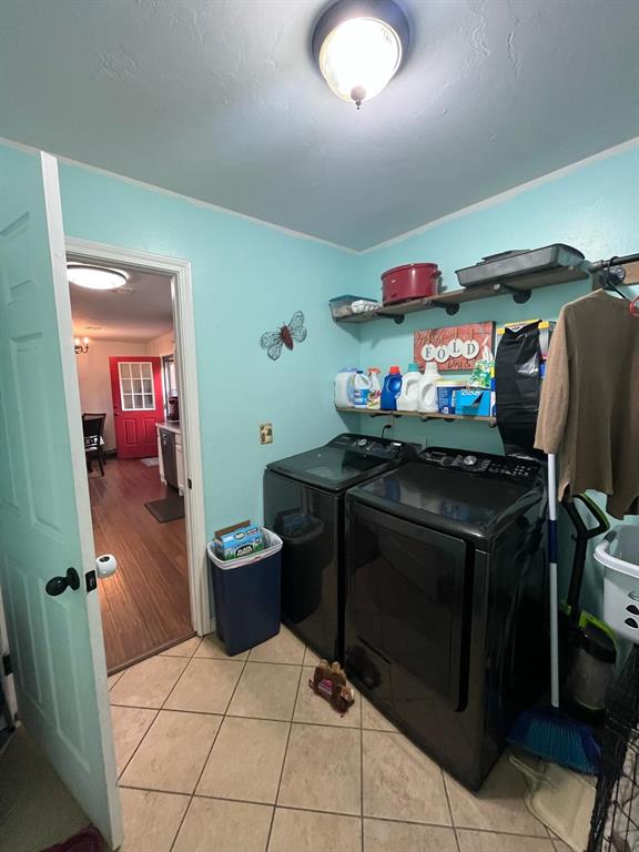 laundry area featuring light tile patterned floors, laundry area, and washer and dryer