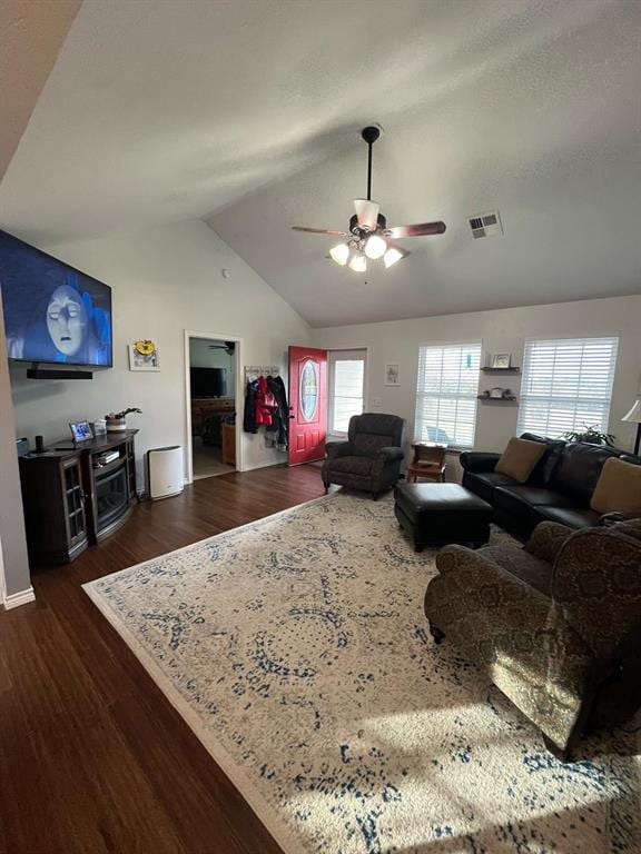 living room featuring lofted ceiling, ceiling fan, dark wood-type flooring, and visible vents