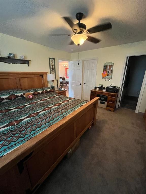 bedroom featuring a ceiling fan, carpet flooring, and a textured ceiling