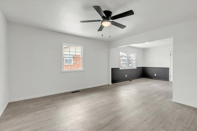 10313 N Mckinley Ave, Oklahoma City, OK 73114 - empty room featuring wood finished floors, baseboards, ceiling fan, and visible vents
