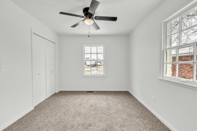 10313 N Mckinley Ave, Oklahoma City, OK 73114 - unfurnished bedroom featuring a closet, carpet flooring, baseboards, and multiple windows